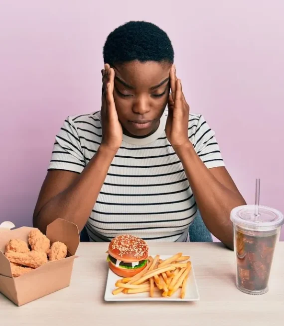 Woman with hands on head - Food and Mood webinar exploring nutrition and mental health