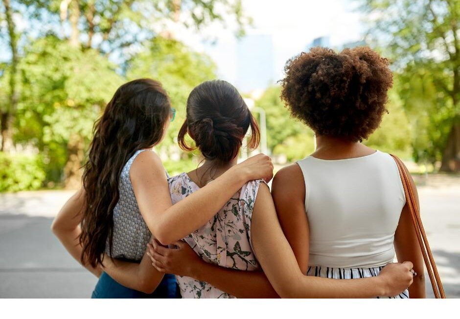 Group of women embracing outdoors - community mental health and collective healing